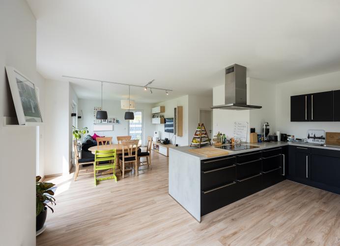 Lichtdurchflutet und großzügig präsentiert sich der Wohn- und Essbereich mit offener Küche.<i> Foto: Roth-Massivhaus / Gerhard Zwickert</i>